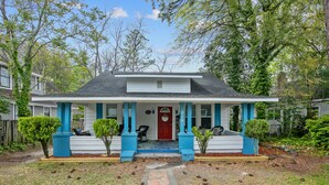 A house with a front porch, a red door, and a mailbox. - Your Newest, Remodeled, and Fully-Furnished AirB&B in the Heart of Fayetteville! (Fayetteville)