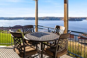 Outdoor dining - Effortless lakefront condo with pool, balcony, grill, fireplace, & beach gear (Lake Ozark)