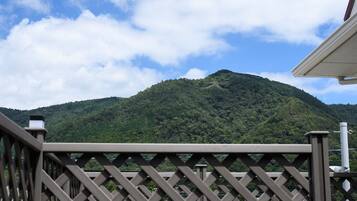 A view of a mountain with a wooden fence in the foreground.