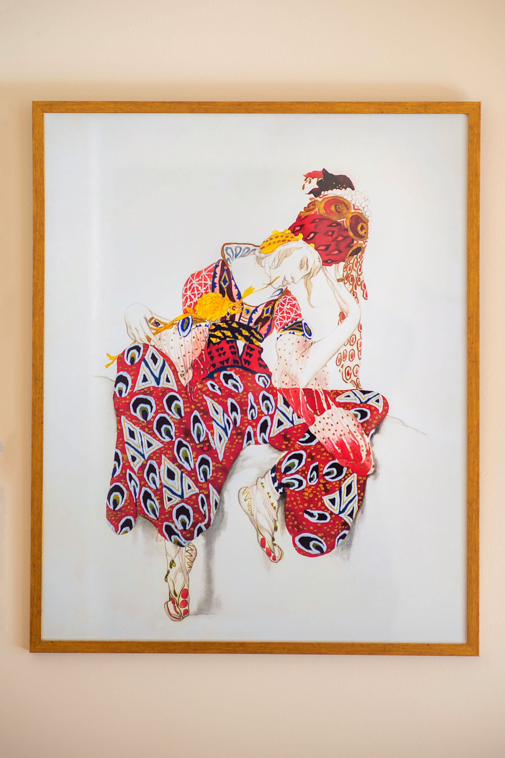 A framed artwork of a dancer in a patterned costume.