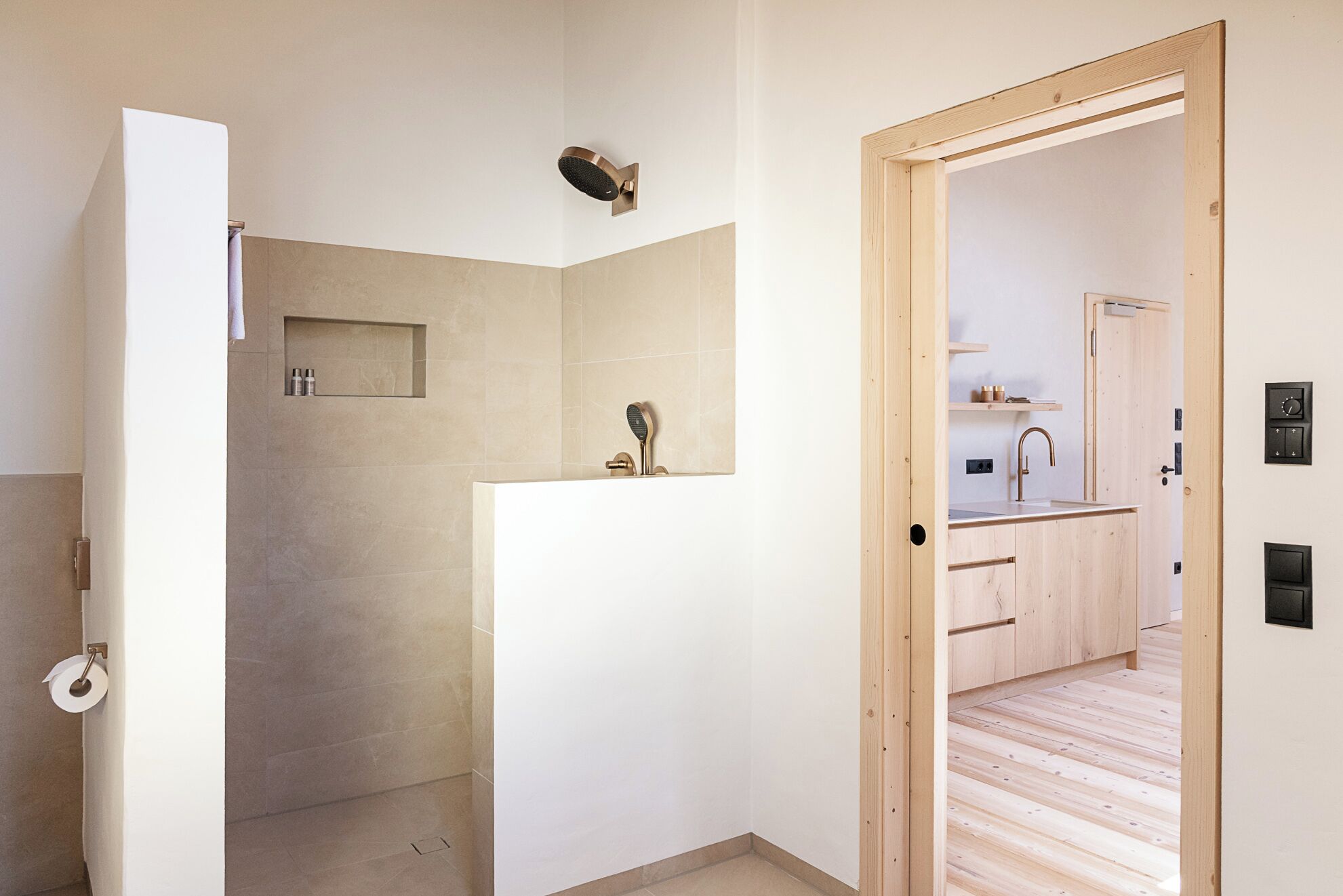 A modern bathroom with a shower, toilet, and sink.