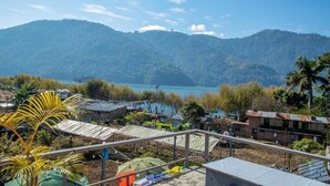 A coastal village with houses and a view of the sea and mountains. - Hostel Nepal Pvt. Ltd. (Pokhara)