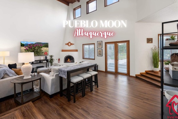 "Spacious and Inviting Living Room with High Ceilings and Modern Decor in Stylish Home - Perfect for Family Comfort and Entertaining Guests"