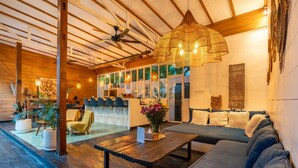 A spacious lobby with a wooden ceiling, a large woven light fixture, and a seating area with a sofa and chairs. - Private Pool • Hot Tub • Near Batu Bolong Beach (Canggu)
