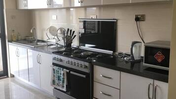 Fridge, microwave, cookware/dishes/utensils