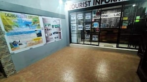 A tourist information center with a tiled floor and glass doors. - Maritonies Place (Coron)