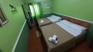 A room with two beds, a mirror, a window with curtains, and a small air conditioning unit. - Maritonies Place (Coron)