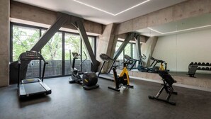 A modern gym with treadmills, stationary bikes, and weight machines. - w* | Amazing loft in Cuauhtemoc (Ciudad de México)