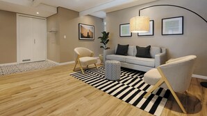 Un soggiorno moderno con divano, poltrone, tappeto decorato e opere d'arte alle pareti.