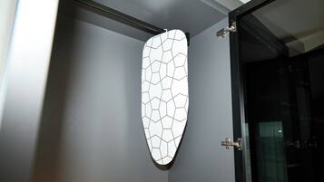 A wall-mounted geometric-patterned object, possibly a decorative panel or artwork, in a room with a modern design.