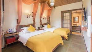 A hotel room with two beds, wooden headboards, and a large window. - fenghelijiang (Lijiang)