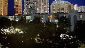 A nighttime cityscape with modern high-rise buildings, some with illuminated windows. - le cartier sunny isles ocean paradise (Sunny Isles Beach)
