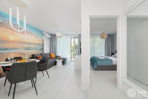 Family Apartment | Living area | 50-inch LCD TV with satellite channels, books