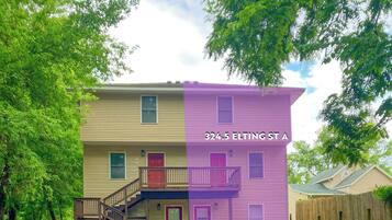 A two-story building with a purple and beige facade, marked with the address 324.5 Elting St A.