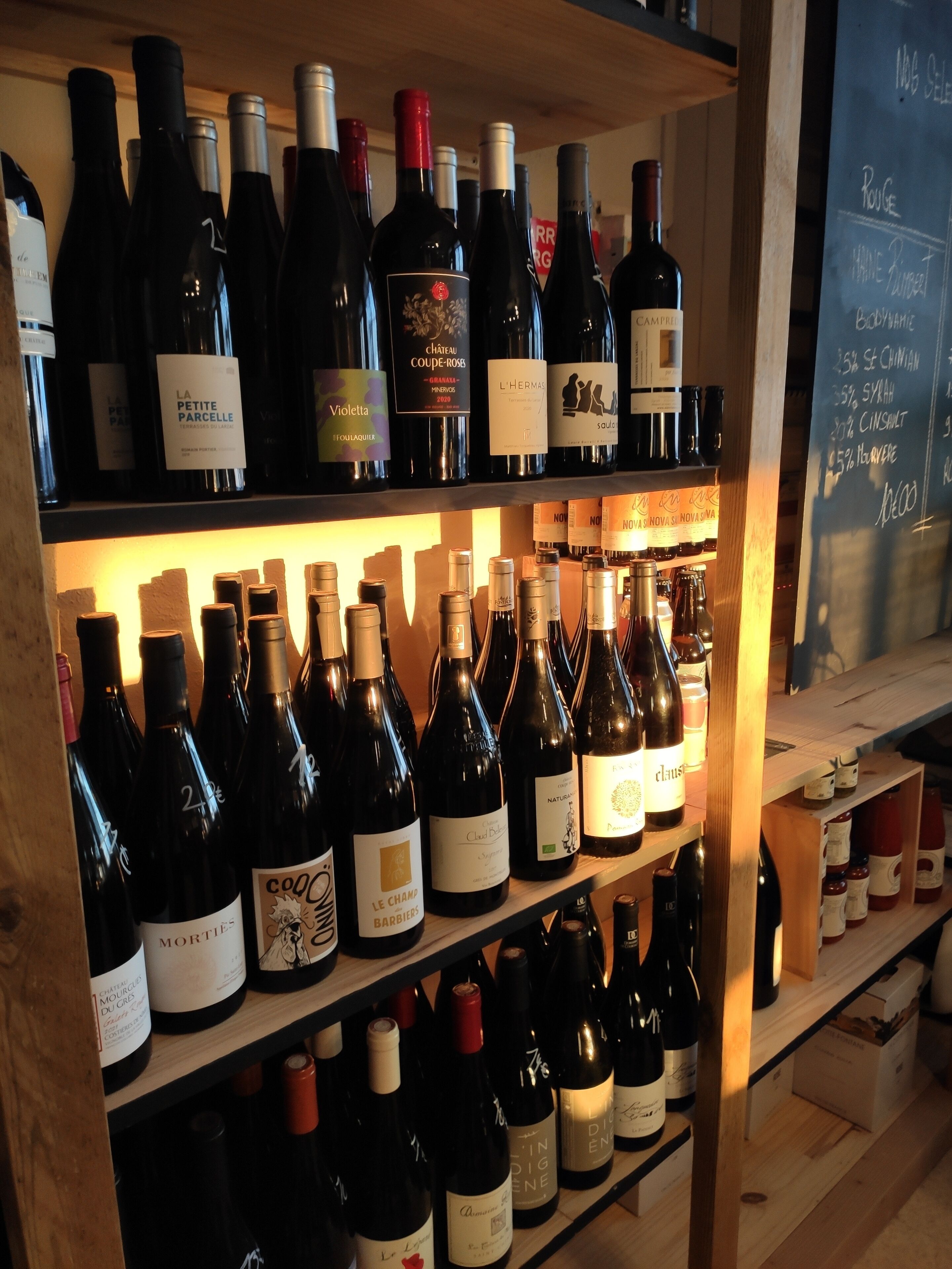 A wine rack with various bottles of wine.