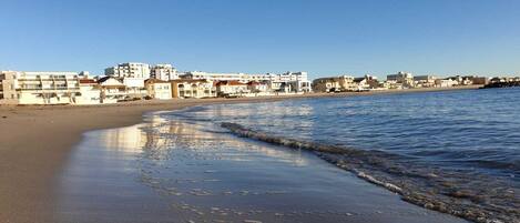 On the beach, white sand, beach umbrellas, beach volleyball