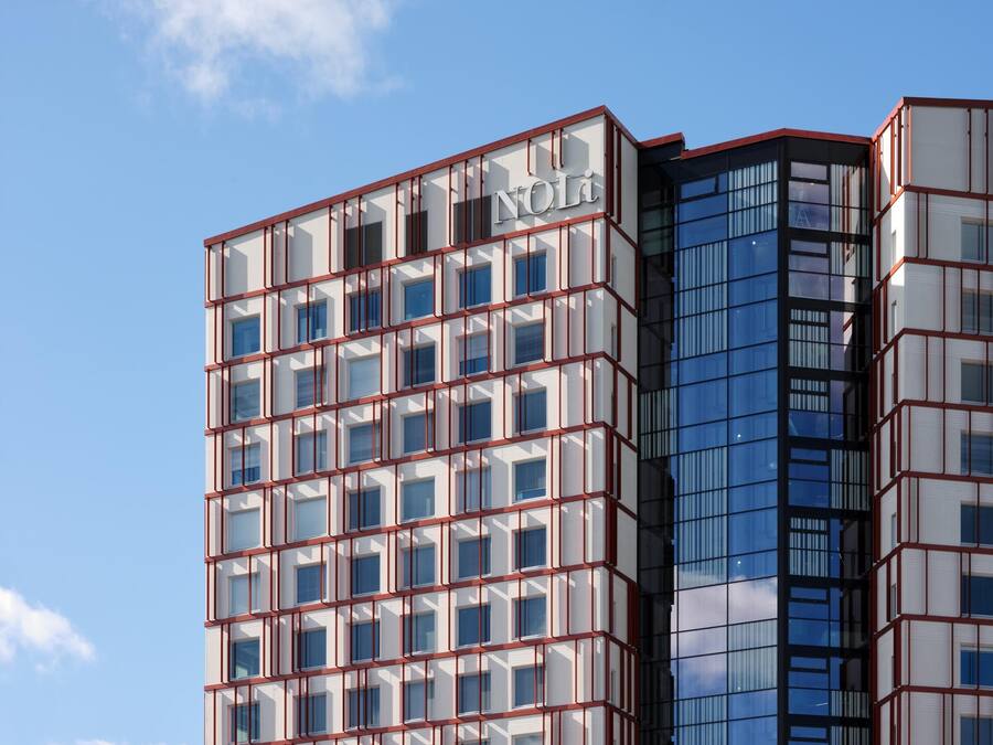 A modern building with a grid of windows and a prominent 'NOL' sign on the top.