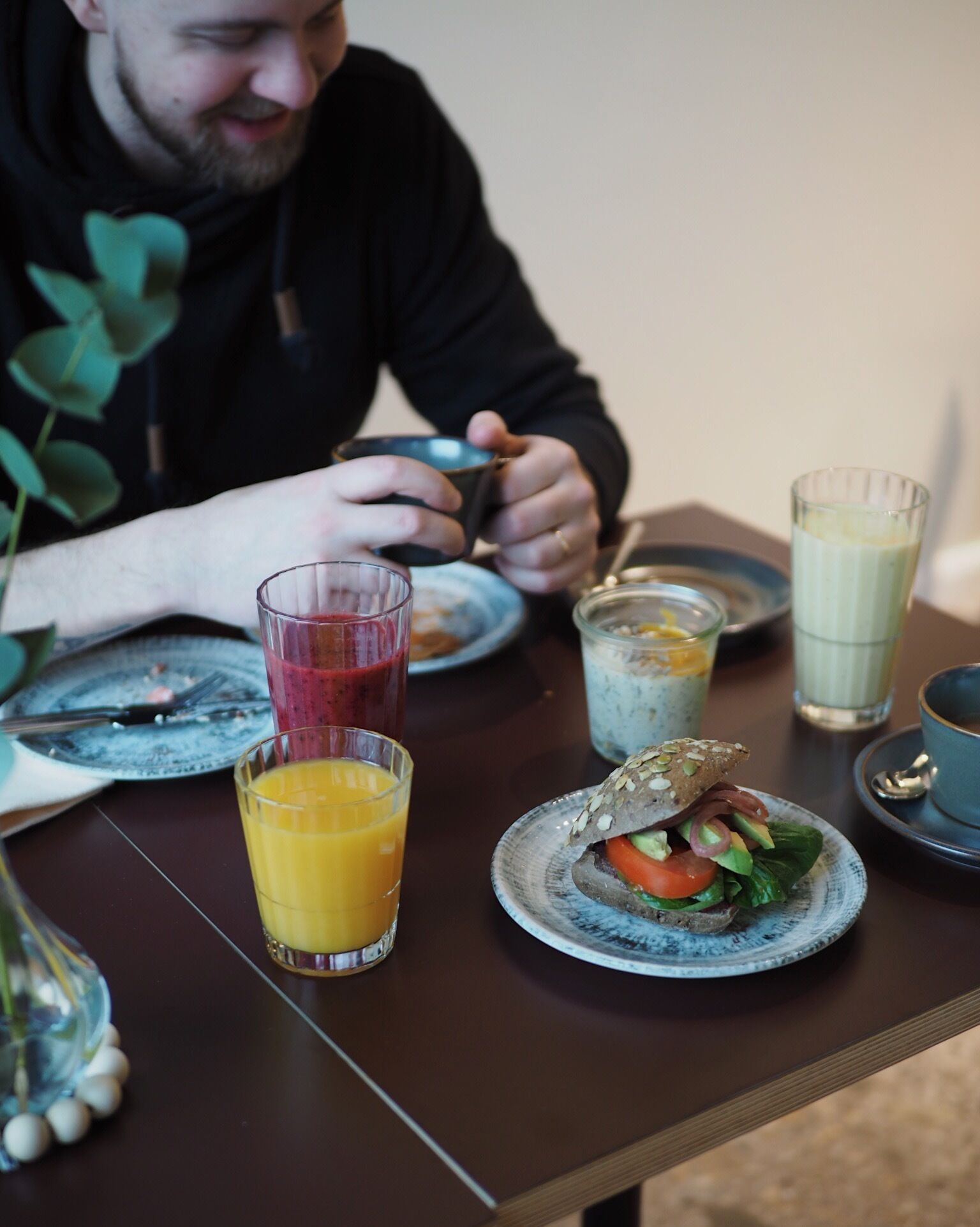 A dining table with various food items and drinks.