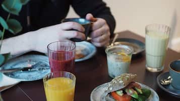A dining table with various food items and drinks.