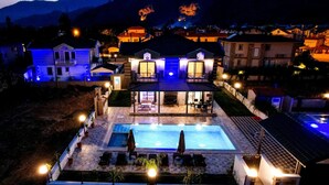 A residential property with a swimming pool, multiple houses, and a mountain backdrop. - BEAUTIFUL 4 BEDROOM VILLA WITH PRIVATE POOL&GARDEN IN HEART OF DALYAN MARAS AREA (Dalyan)