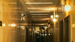 A corridor with reflective marble flooring, recessed lighting, and wall sconces. - Mo-House Hotels and Apartments (Abuja)