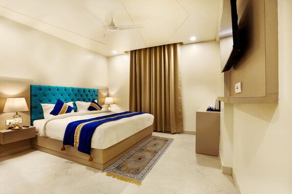 Relax in comfort with a large bed, flat-screen TV, and convenient bedside table.