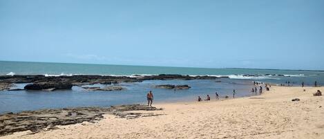 On the beach, white sand, beach umbrellas, beach towels