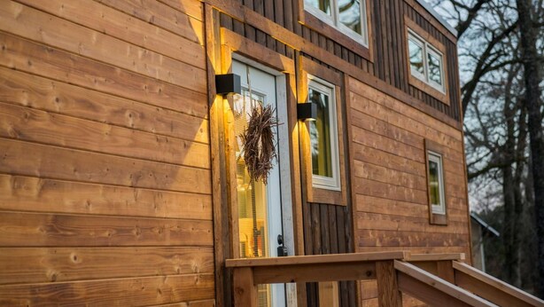 A wooden cabin with a front door, two windows, and a small porch. - Montana Escape Tiny House in Waco 12 min to Magnolia and Baylor (Waco)