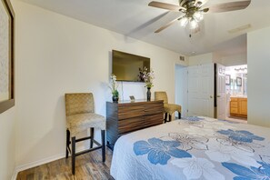 A bedroom with a bed, a dresser, two chairs, a ceiling fan, and a door leading to another room. - PCB Condo w/ Pool Access: 1 Mi to Beach! (Panama City Beach)