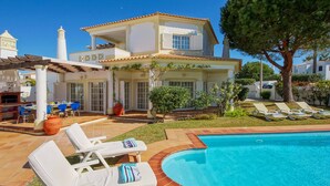 A two-story house with a swimming pool, outdoor seating, and a pergola. - Villa Costa Rica - Four Bedroom Villa, Sleeps 8 (Algarve)