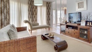 A living room with a sofa, a coffee table, a TV, and a cabinet. - Villa Costa Rica - Four Bedroom Villa, Sleeps 8 (Algarve)