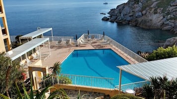 Seasonal outdoor pool, open 8:00 AM to 7:30 PM, pool umbrellas