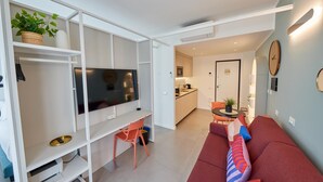 A modern living room with a TV, sofa, and dining area. - New apartment Central Station Milan (Milano)