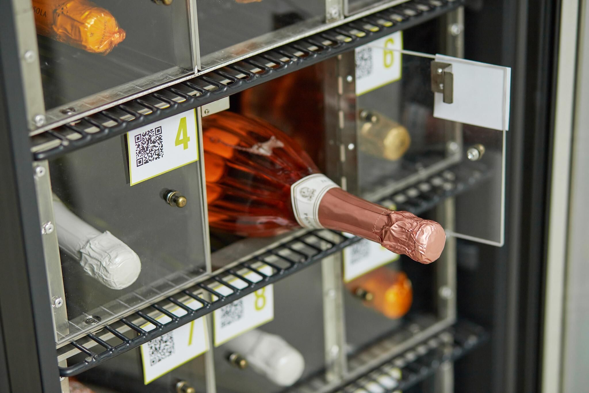 A storage unit with numbered compartments, each containing different items like bottles and containers.
