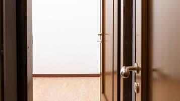 A doorway leading to a room with a tiled floor and a plain wall.