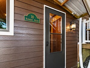 A house number sign, a dark-colored door, and a small porch with a railing. - Slope Side Amazing Location (Snowshoe)