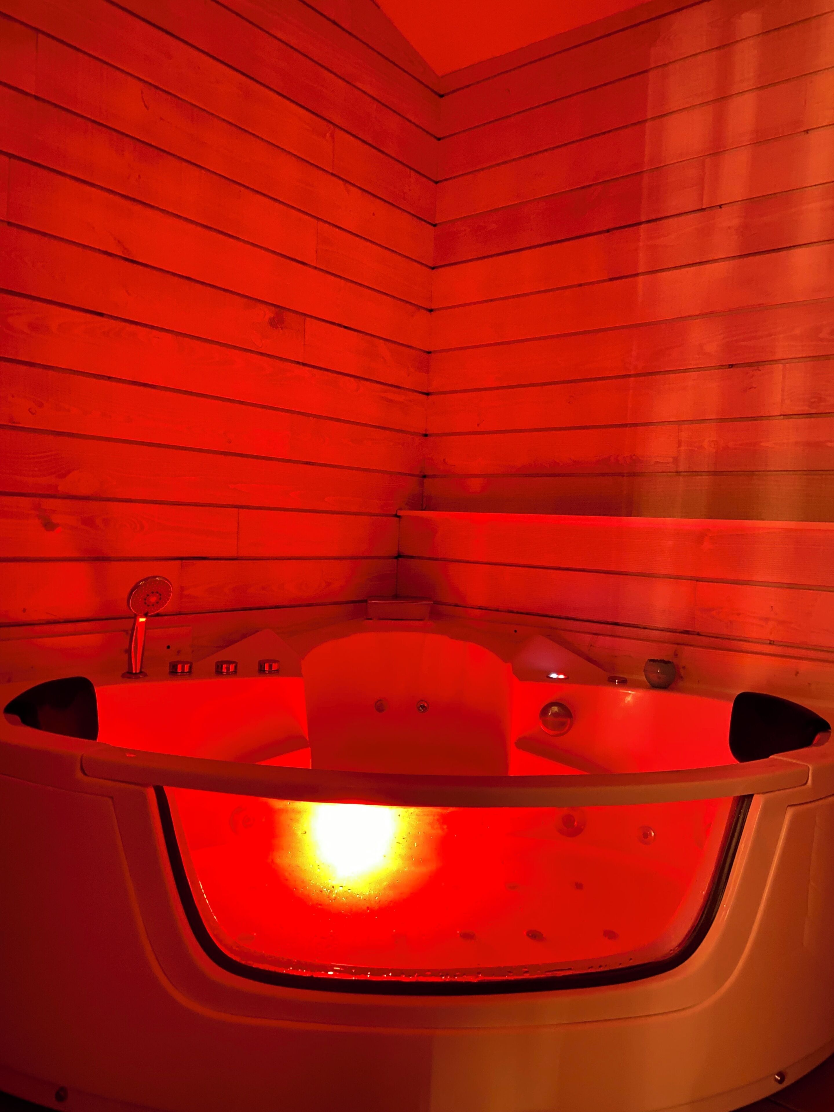 A wooden cabin with a hot tub.