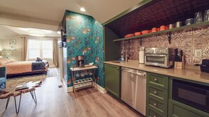 A modern kitchen with a green cabinet, a coffee machine, and a toaster. - Hidden Gem Carriage House—Stylish & Walkable CLT Stay! (Charlotte)