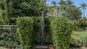 A water feature with a central spout surrounded by lush greenery. - Waking up in a tropical reserve with the sound of the sea caressing your soul. (Río Grande)