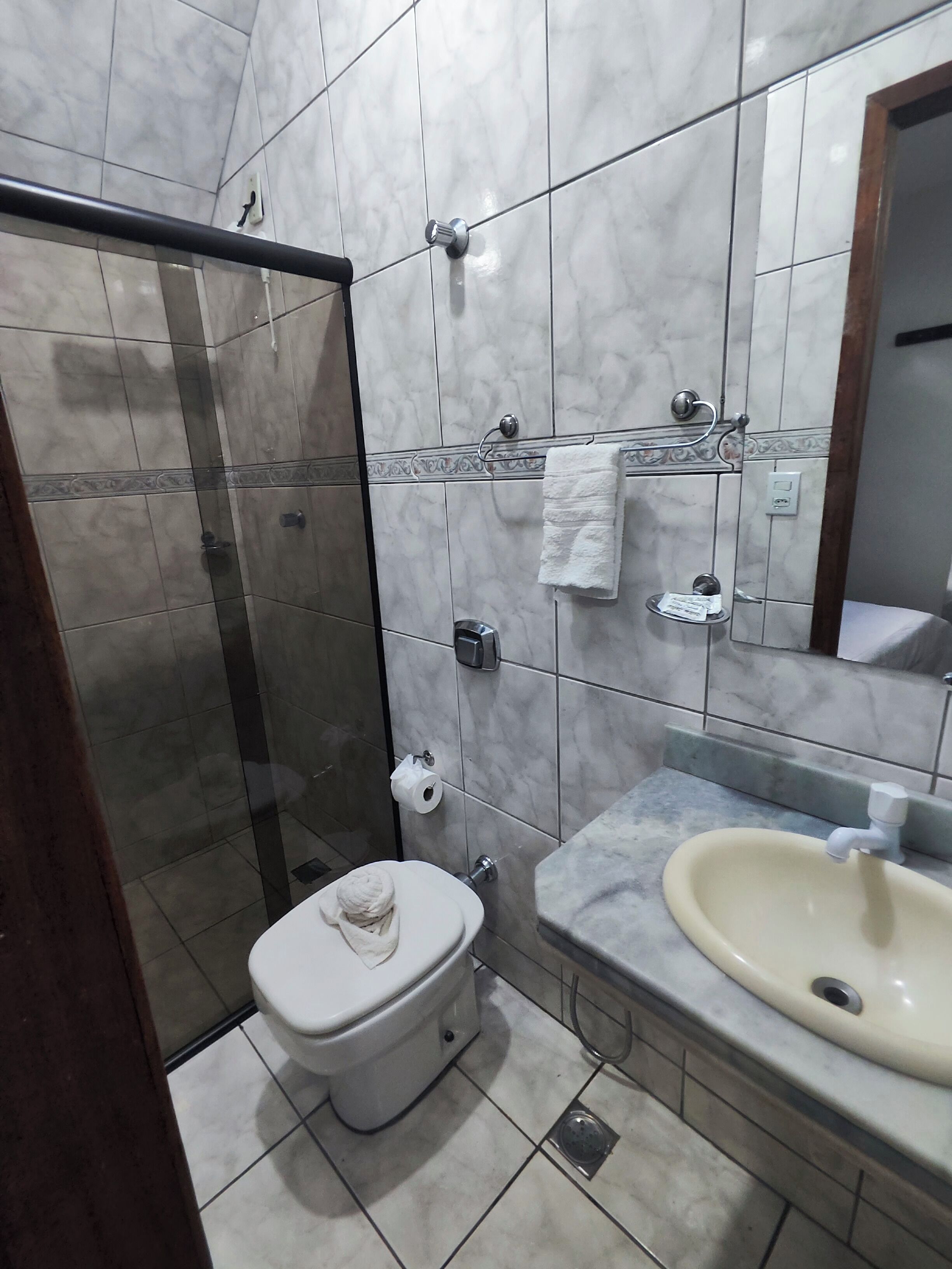 Un baño con inodoro, lavamanos y ducha.