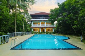 A two-story building with a swimming pool in front. - Once Upon The River (Aluva)