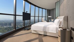 A modern hotel room with a large bed, a TV, and a view of the city. - Wyndham Foshan Nanhai (Foshan)