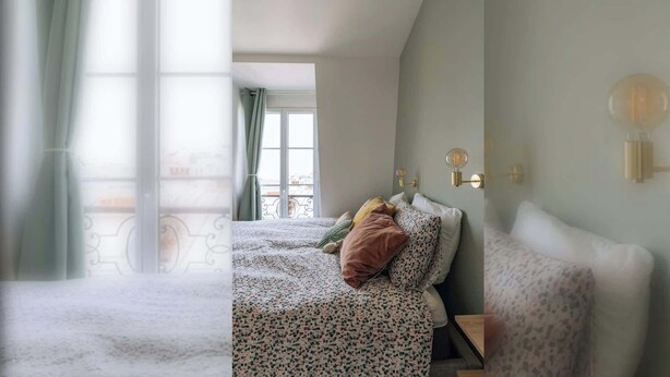 Une chambre à coucher avec un lit, une fenêtre avec des rideaux et un luminaire fixé au mur.