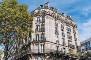 A historic building with ornate iron balconies and a classic architectural style. - Top Floor 2BD Apartment Amazing Views—Montmartre! (Paris)