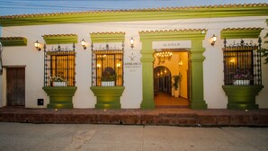 A building with green columns and a sign reading "Literarium Hotel".