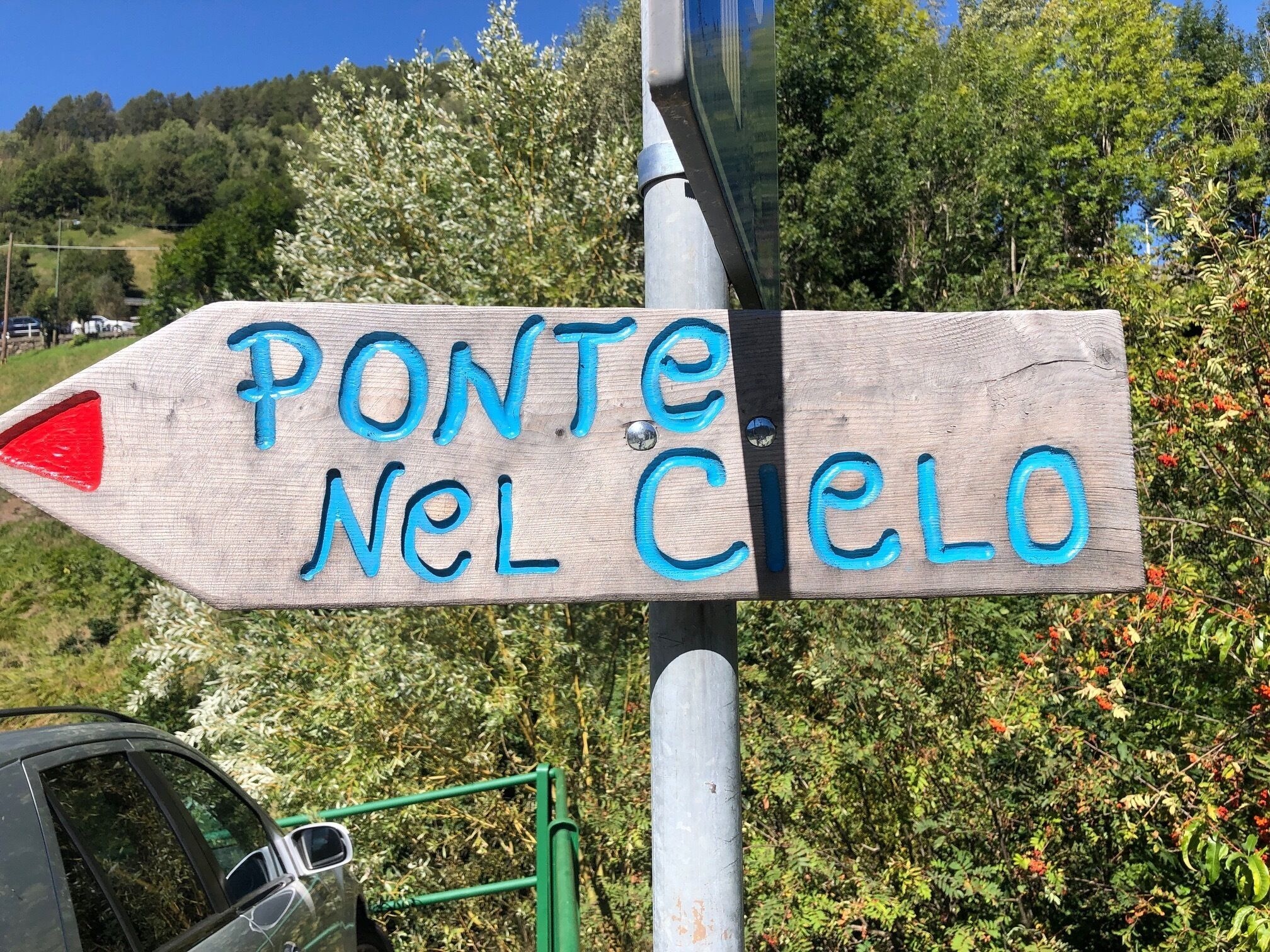 Een houten bord met de tekst 'PONTE NEL Cielo' dat naar rechts wijst.