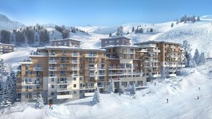 A multi-story hotel with balconies, situated in a snowy mountainous area with ski slopes visible in the background. - 4th floor, balcony, tv, 82m², La Plagne (Aime)