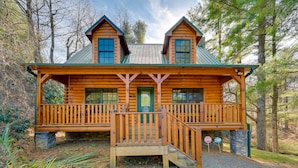 A log cabin with a front porch, a green door, and a sign indicating it is a cabin. - On-Site Waterfall! Cabin Near Blue Ridge Pkwy (Ennice)