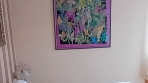 A room with two beds, each with white bedding and pillows, a wooden headboard, and a wall-mounted painting of flowers. - Pension u Dubu (Frantiskovy Lazne)