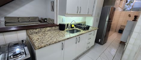 Fridge, microwave, cookware/dishes/utensils, dining tables